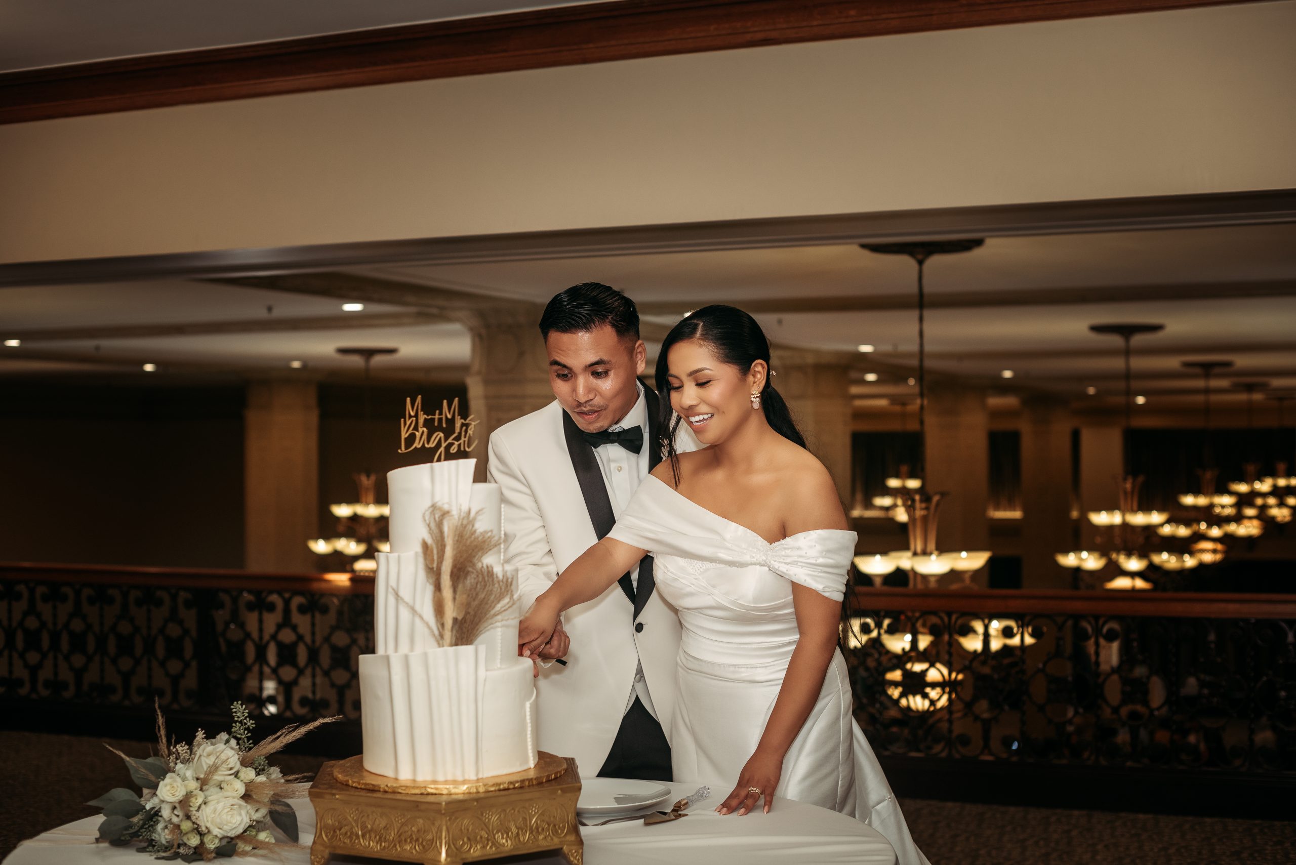 Happy Couple Cutting Wedding Cake in Downtown Fresno Wedding Venue